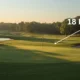 Sunrise view of an 18-hole golf course with fairways and flagstick.